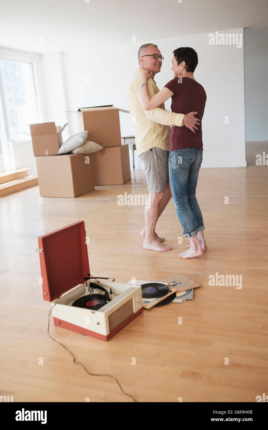 Couple dancing in new apartment Stock Photo