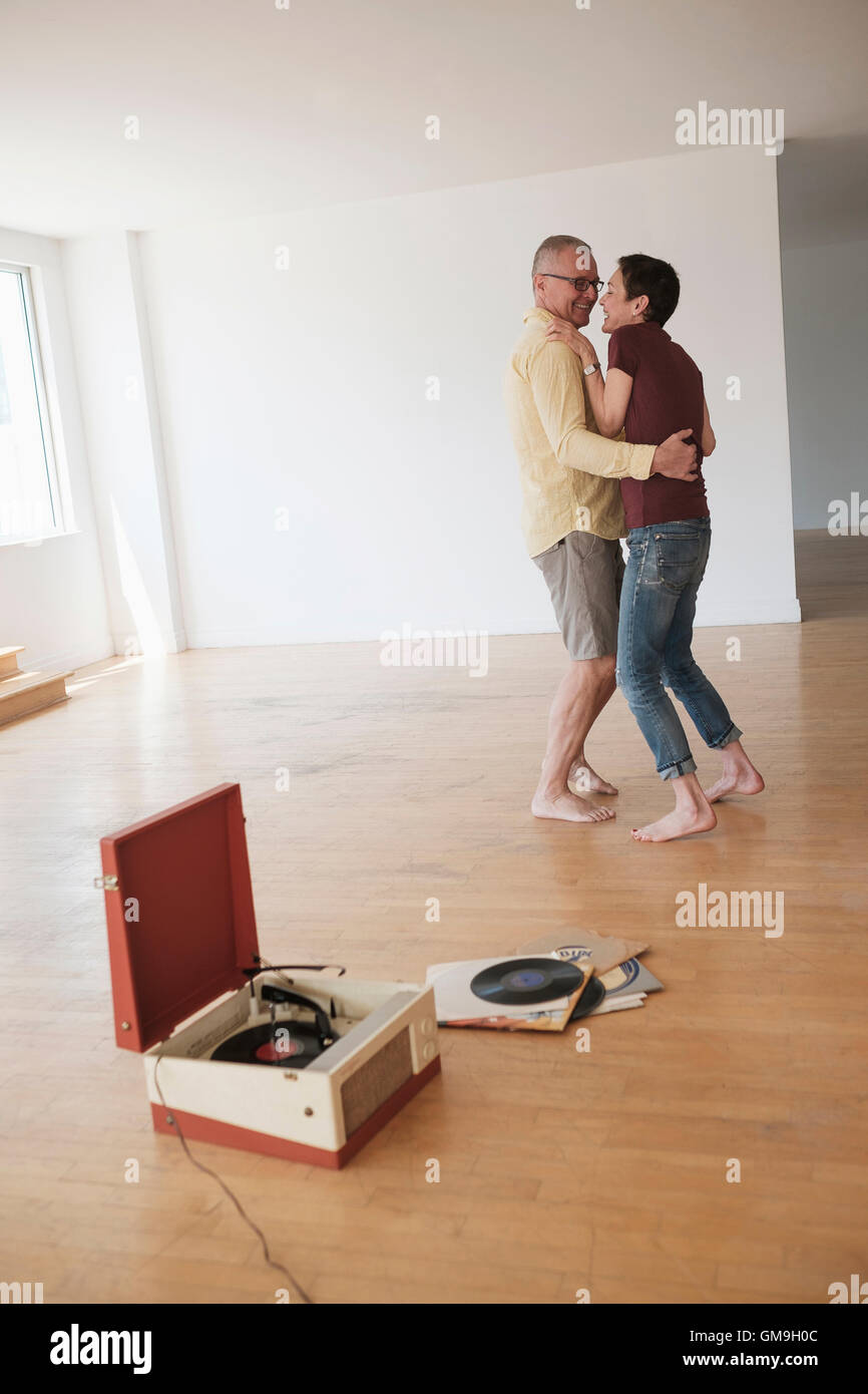 Couple dancing in new apartment Stock Photo