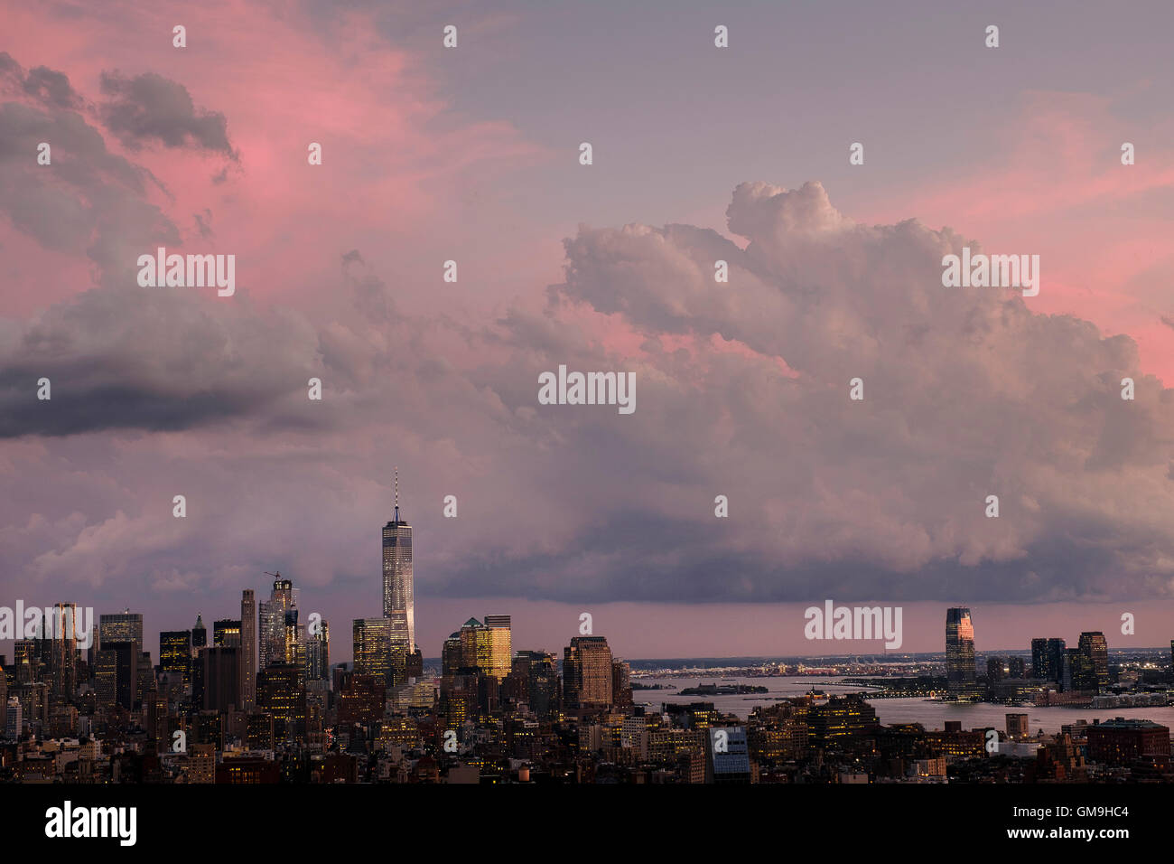 City skyline under dramatic pink sky Stock Photo