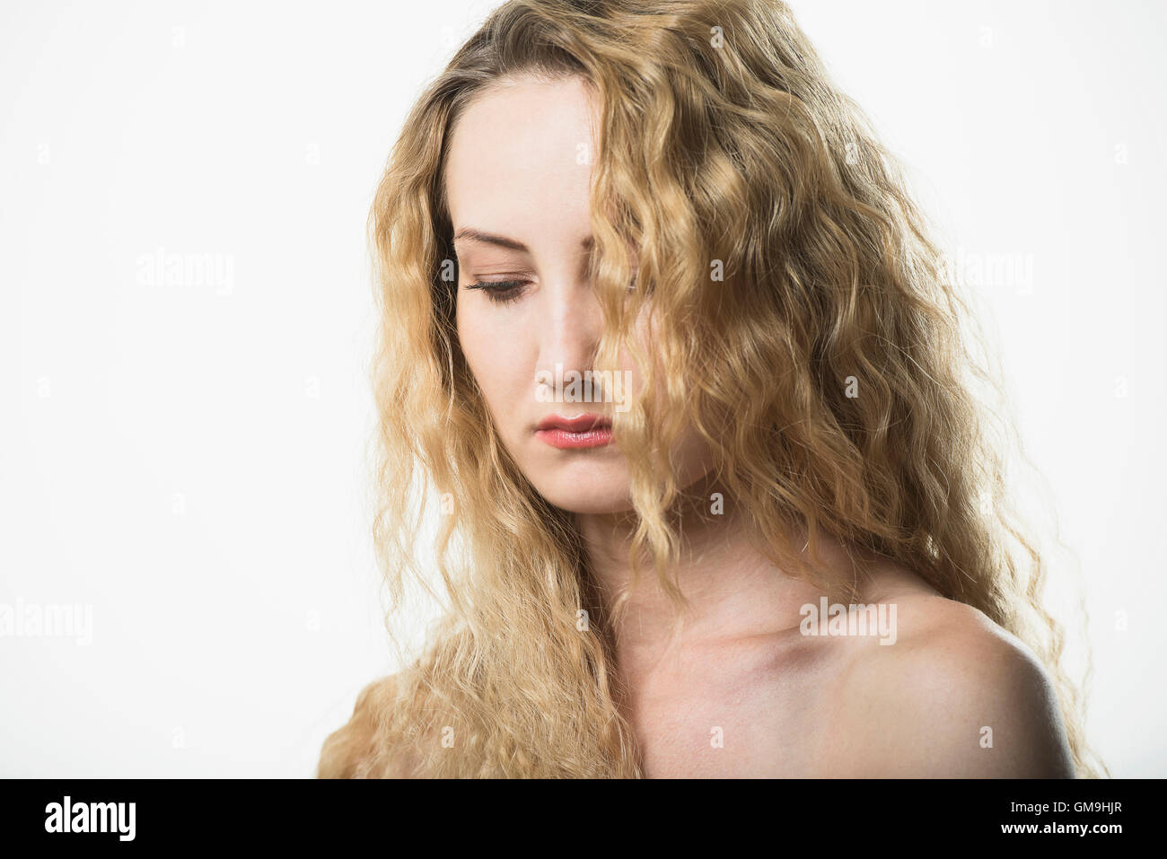 Portrait of beautiful woman with long, blond, curly hair Stock Photo