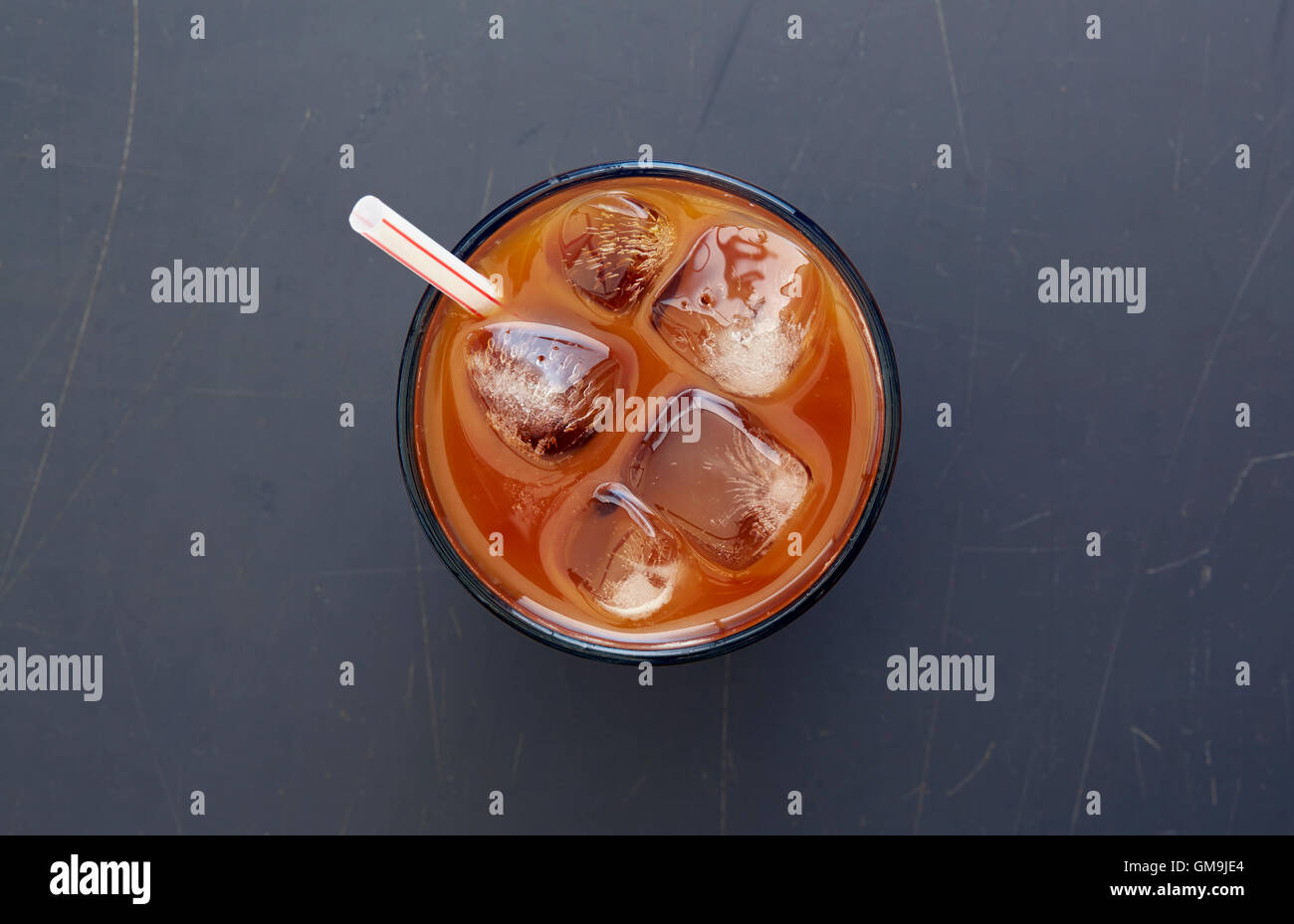 Overhead view of iced coffee with drinking straw Stock Photo