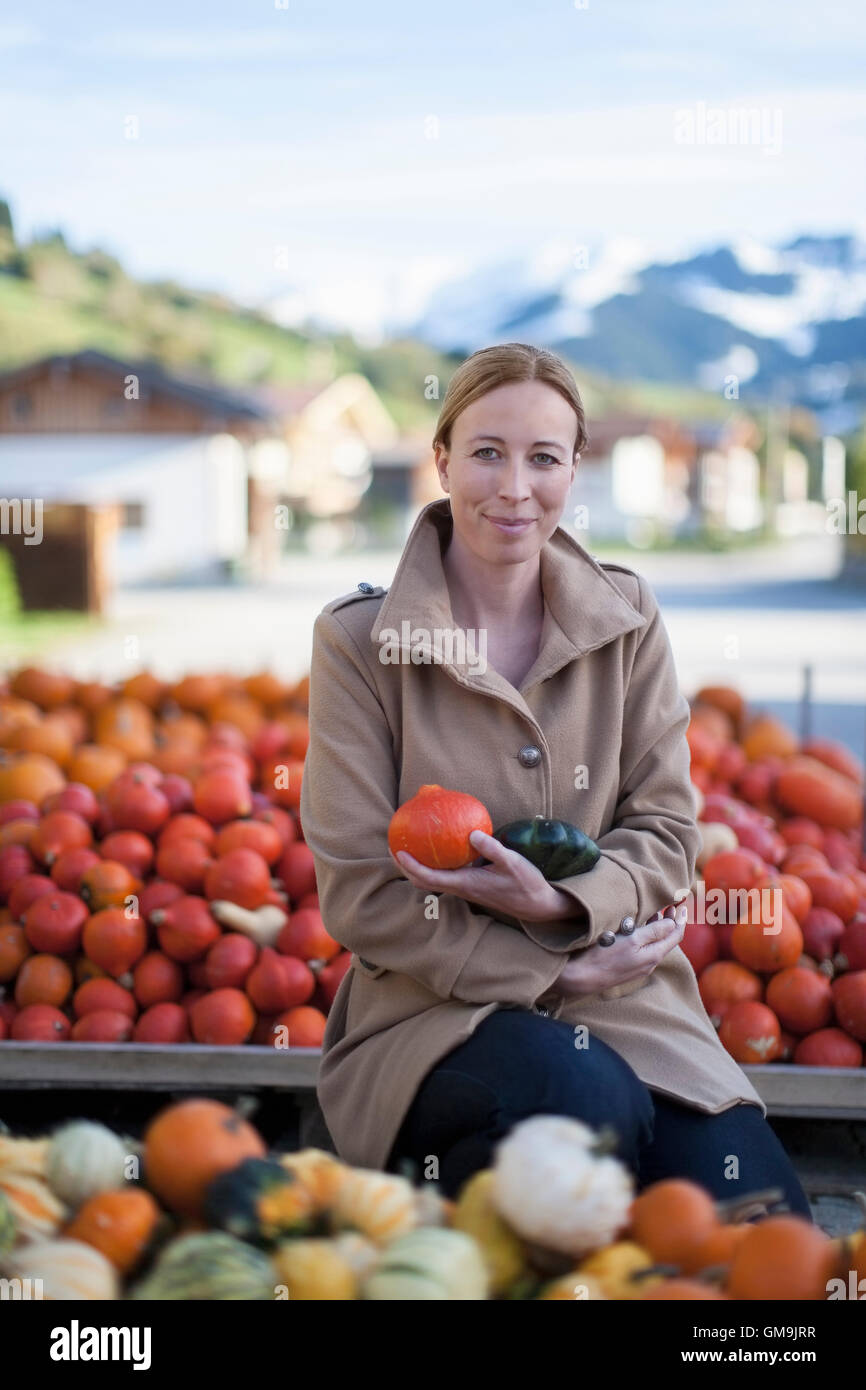 Austria, Salzburger Land, Maria Alm, Portrait of mature woman holding vegetables Stock Photo