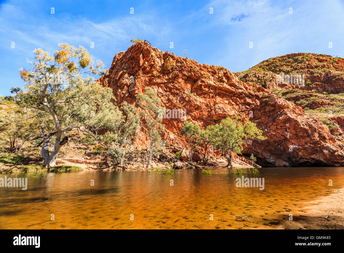 Australia, Outback, Northern Territory, Red Centre, West Macdonnel Ranges, Ormiston Gorge, Orange colored lake in red rock mountains Stock Photo