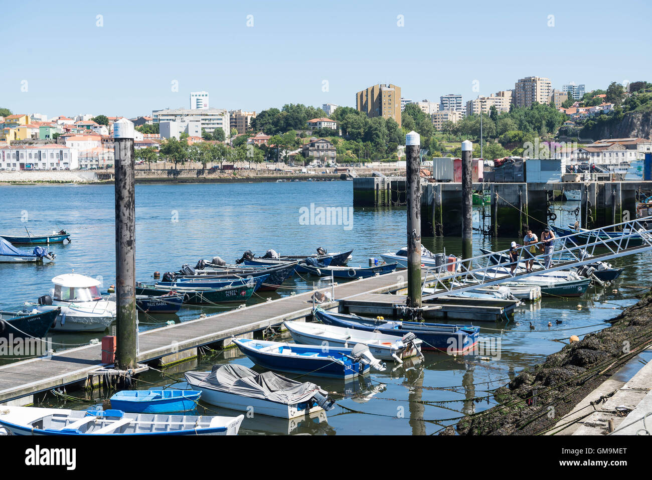 The marina near the small fishing village of Afurada, Portugal. The city of Porto visible on the other side of the river Douro. Stock Photo