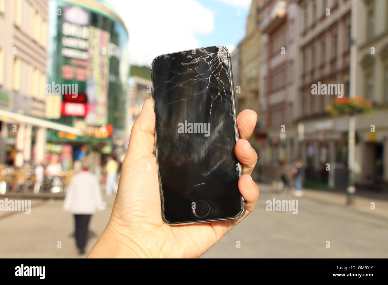 This iPhone5 by Apple is damaged and thus it does not work. Stock Photo