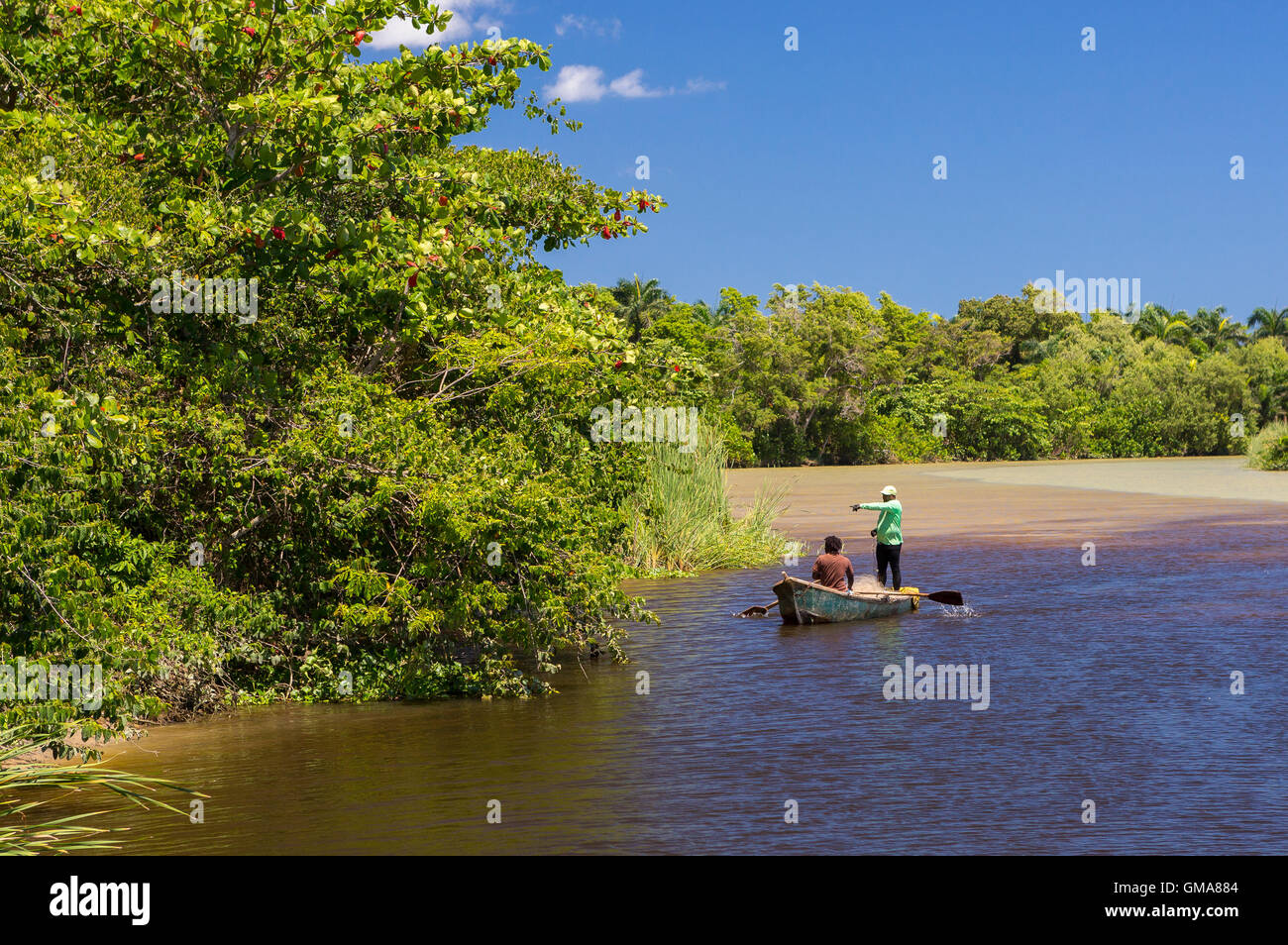 DOMINICAN REPUBLIC - Fishermen in rowboat on Yasica River Stock Photo