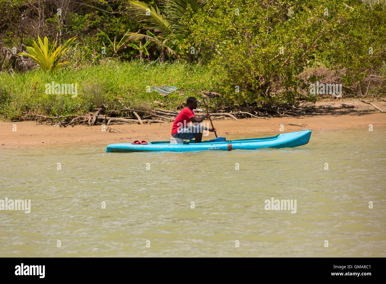CABARETE, DOMINICAN REPUBLIC Man in small boat fishing for blue crabs