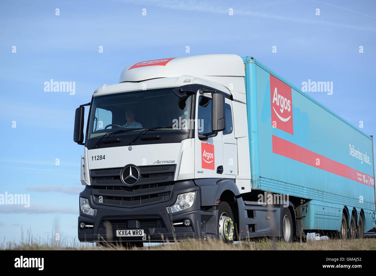 An Argos Mercedes-Bents Actros truck driving along a rural road on a bright Autumn day Stock Photo