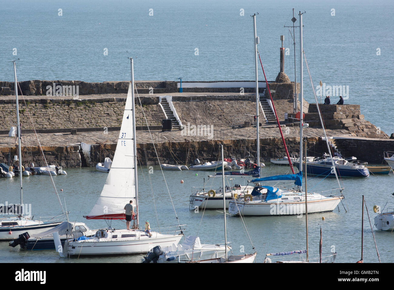 Newquay Harbour on a sunny day in the summer, with people on their boats, yachts Stock Photo