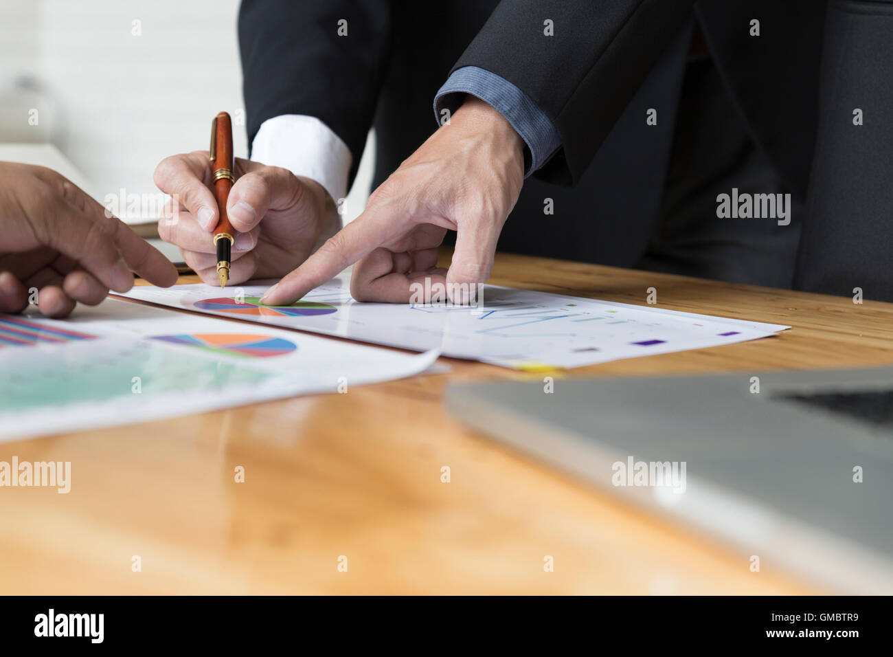 businessman meeting, analyzing and discussing with laptop computer and ...