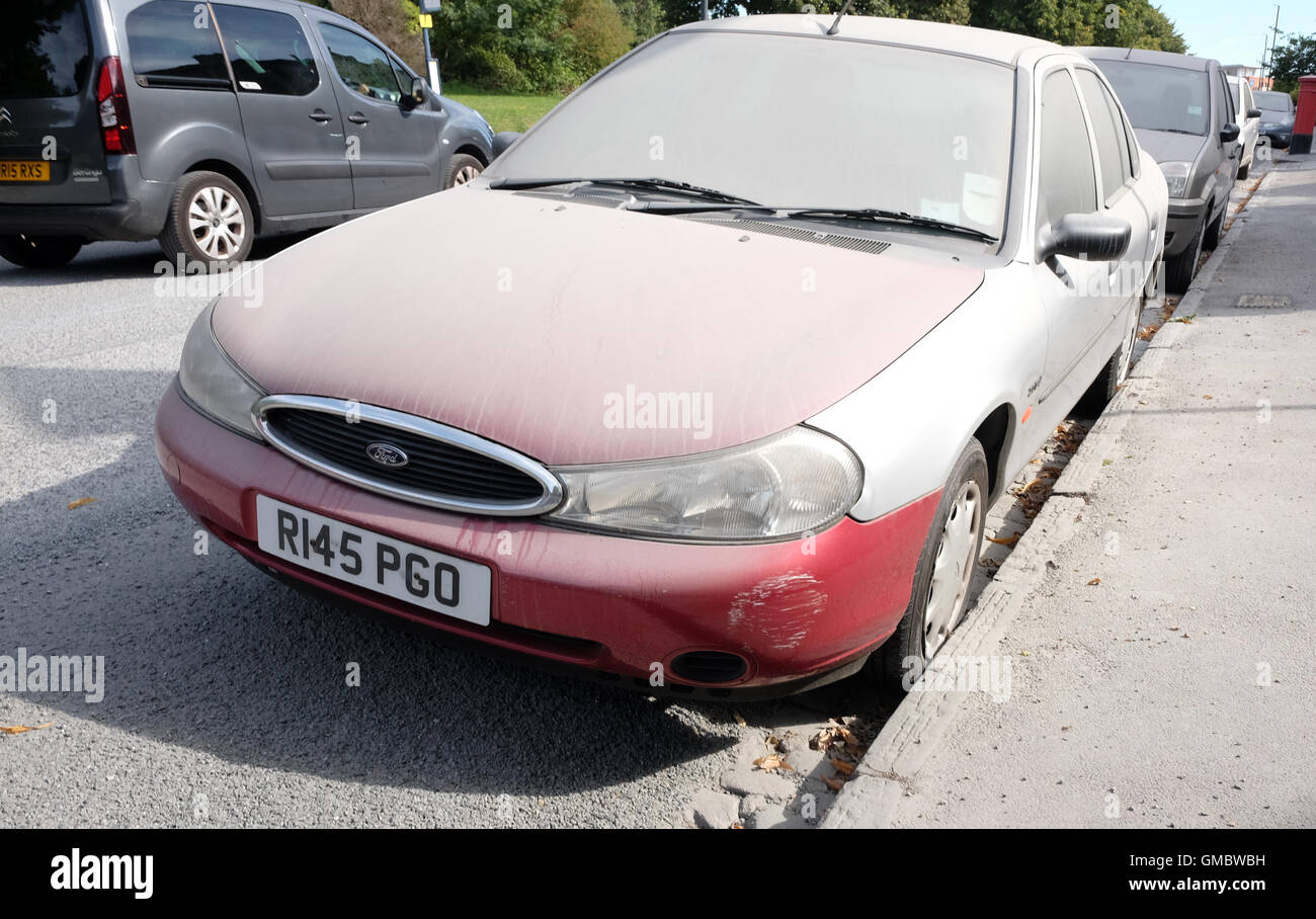 Very dirty and dusty cars parked where surface dressing has been taking