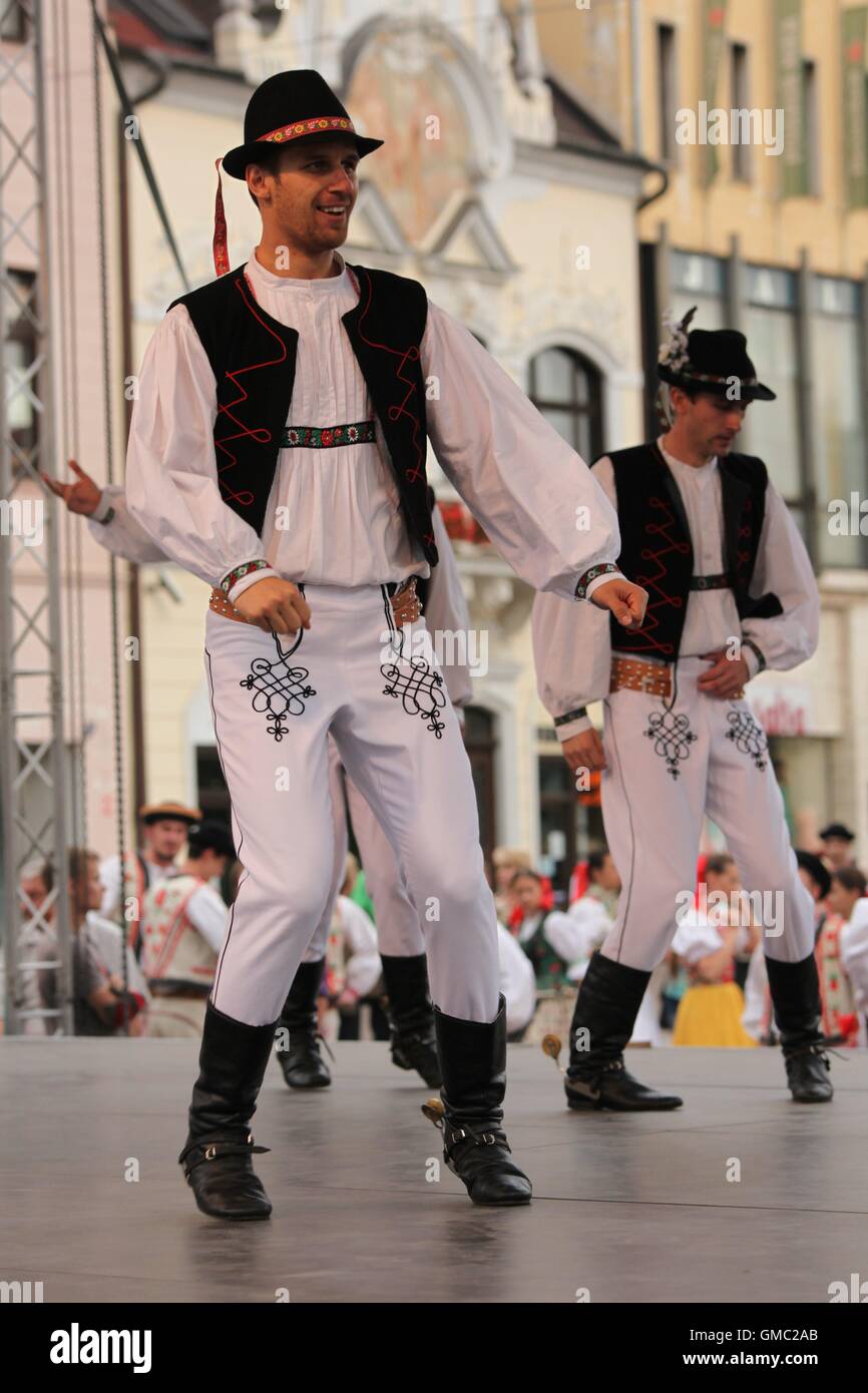 Men dressed in traditional costumes from eastern Slovakia dancing