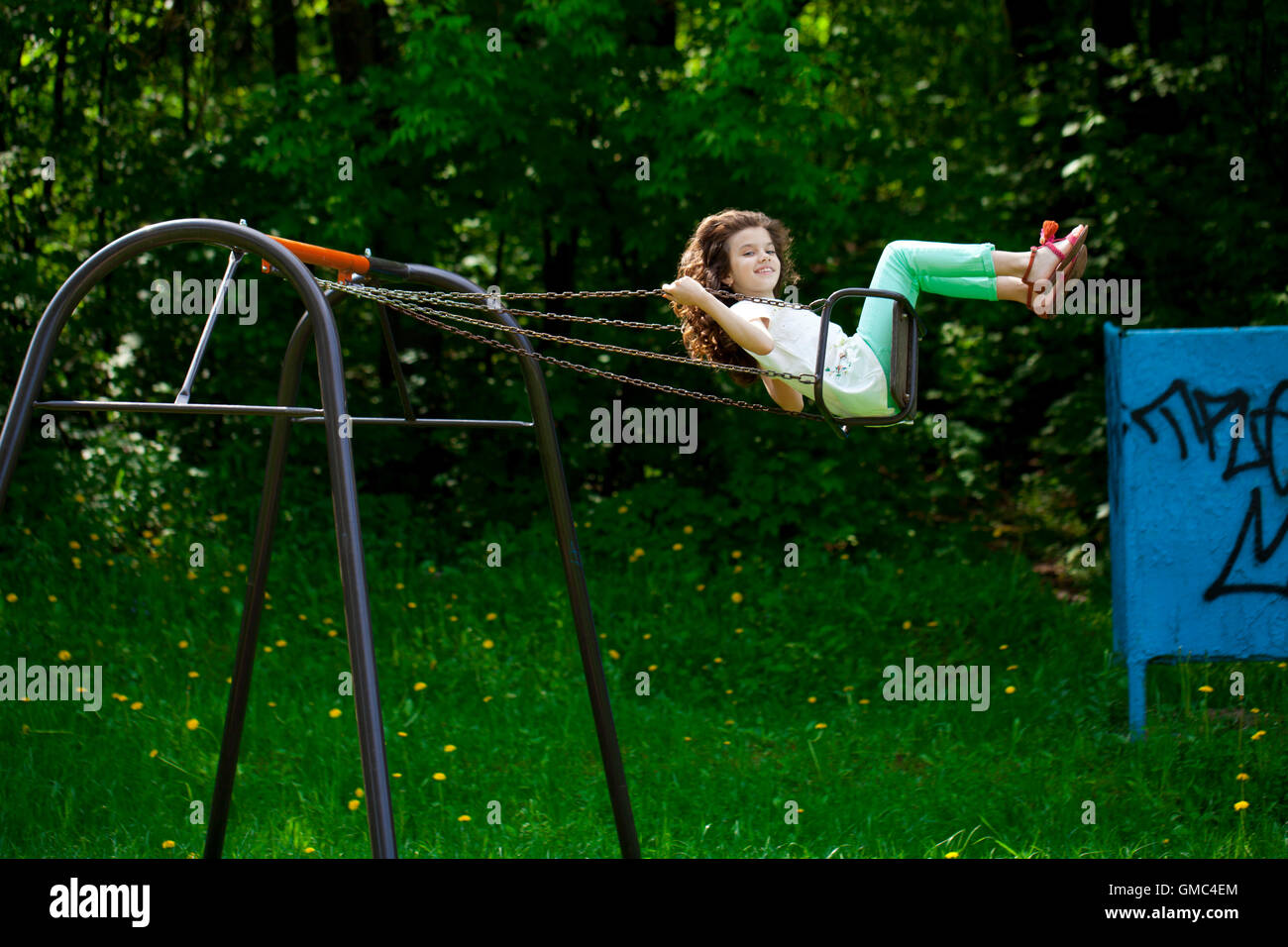 Boy and girl sharing swing on summer day in Sweden Stock Photo - Alamy