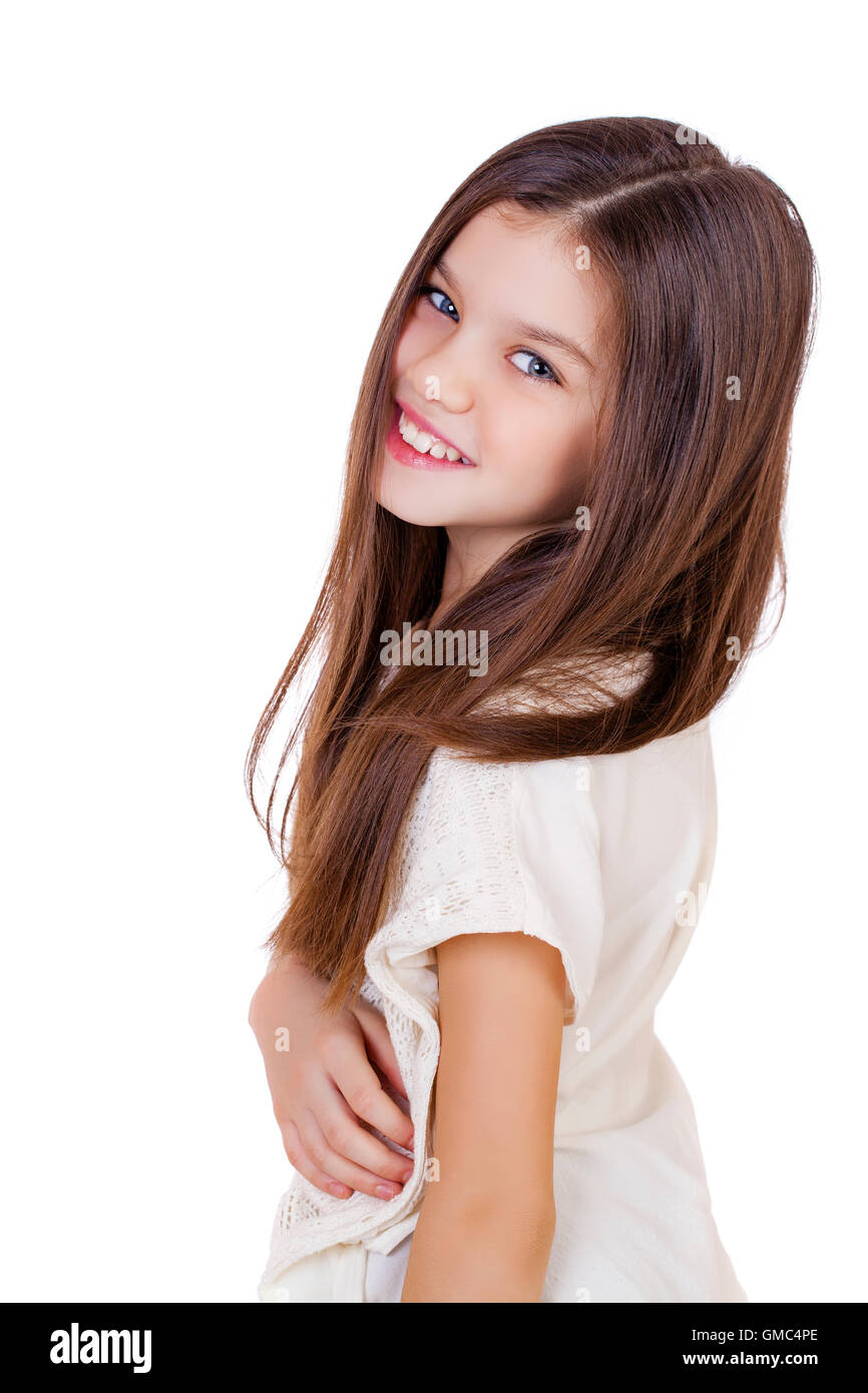 Portrait of a charming little girl smiling at camera, isolated on white ...