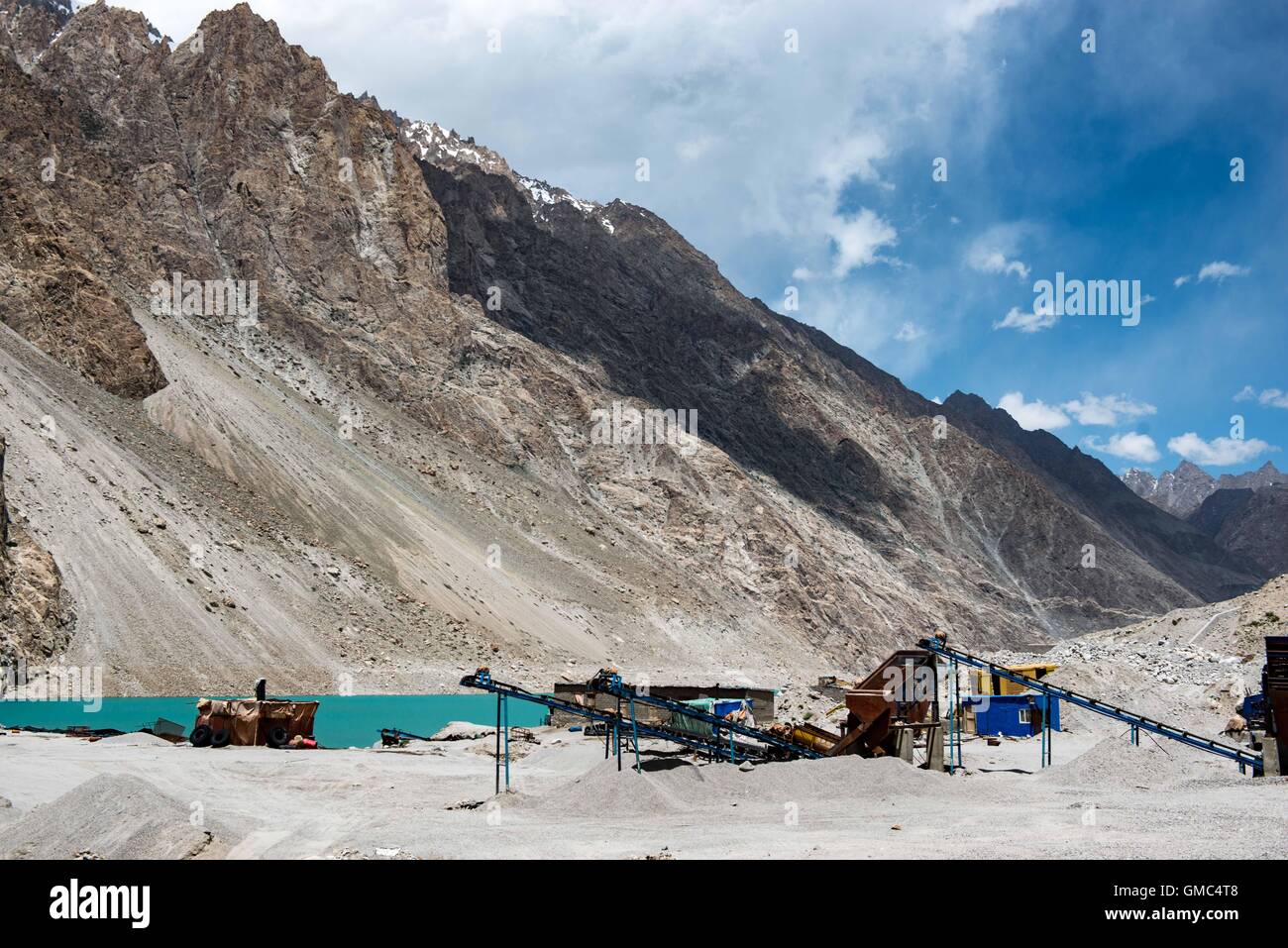 Gravel extraction machinery on the banks of Attabad lake in northern Pakistan Stock Photo