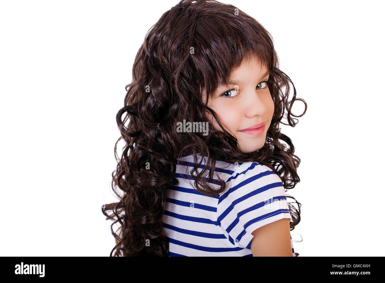 Portrait of a charming little girl smiling at camera, isolated on white ...