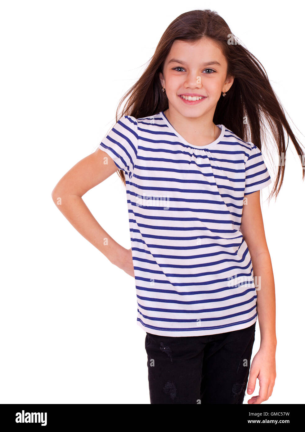 Portrait of a charming little girl smiling at camera, isolated on white ...