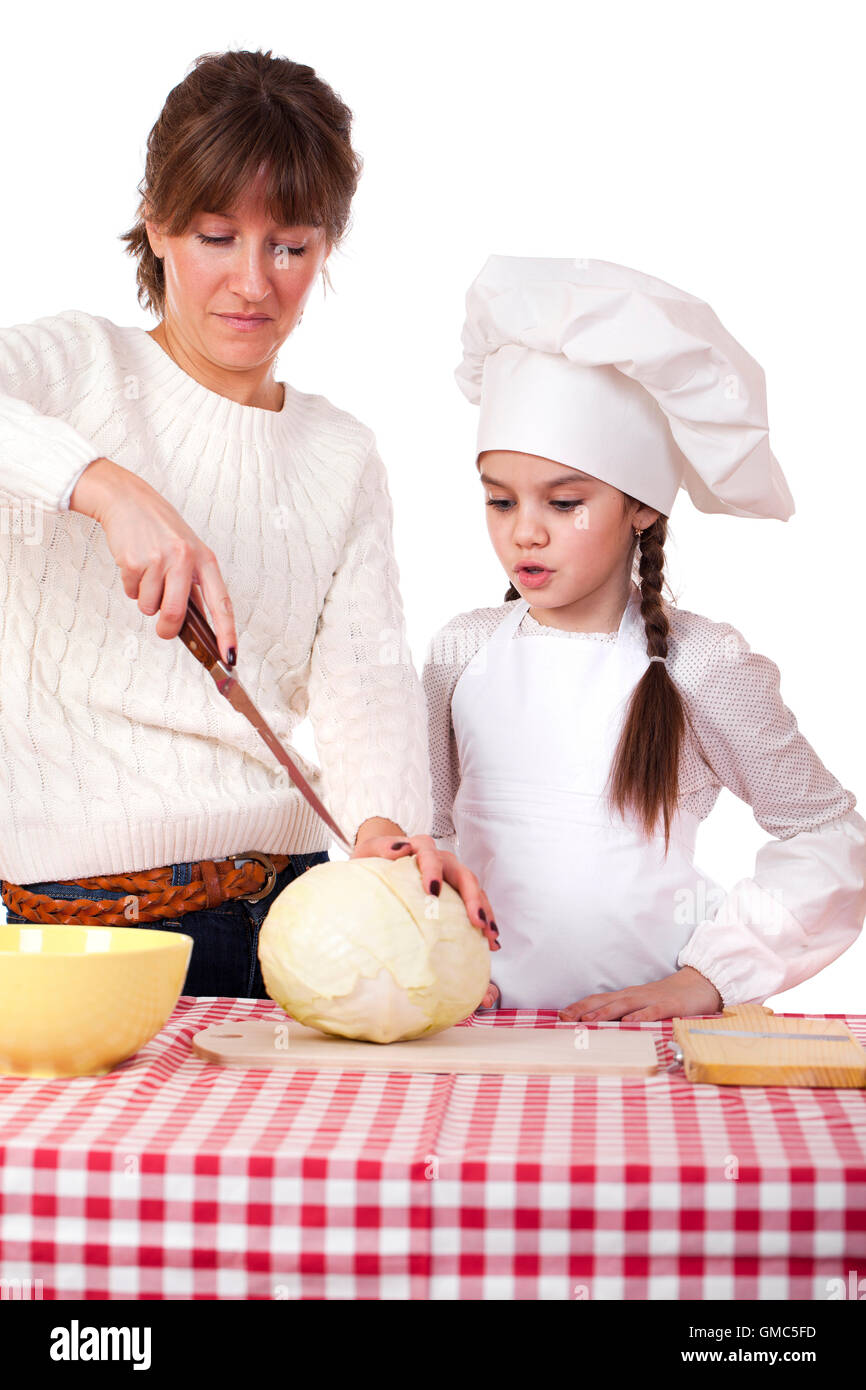 Cooking and people concept - Little girl in cook hat and mother, isolated on white background Stock Photo