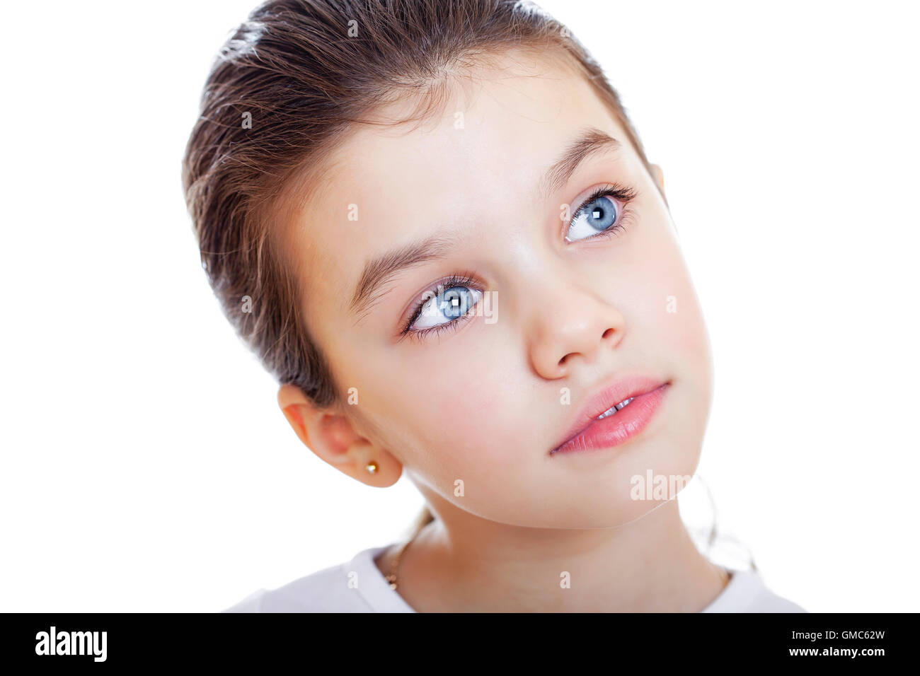 Portrait of a charming little girl smiling at camera, isolated on white ...