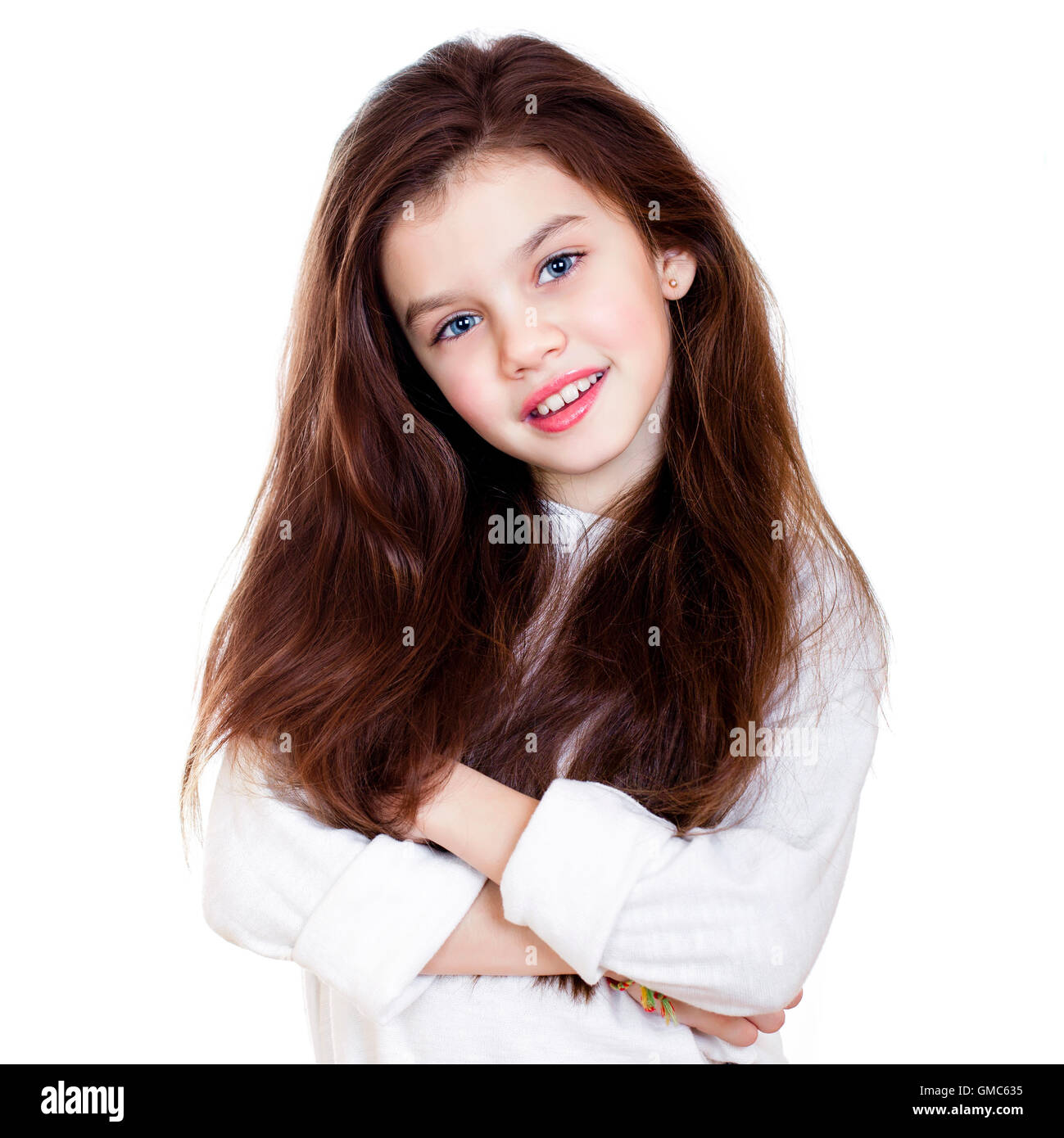 Portrait of a charming little girl smiling at camera, isolated on white ...