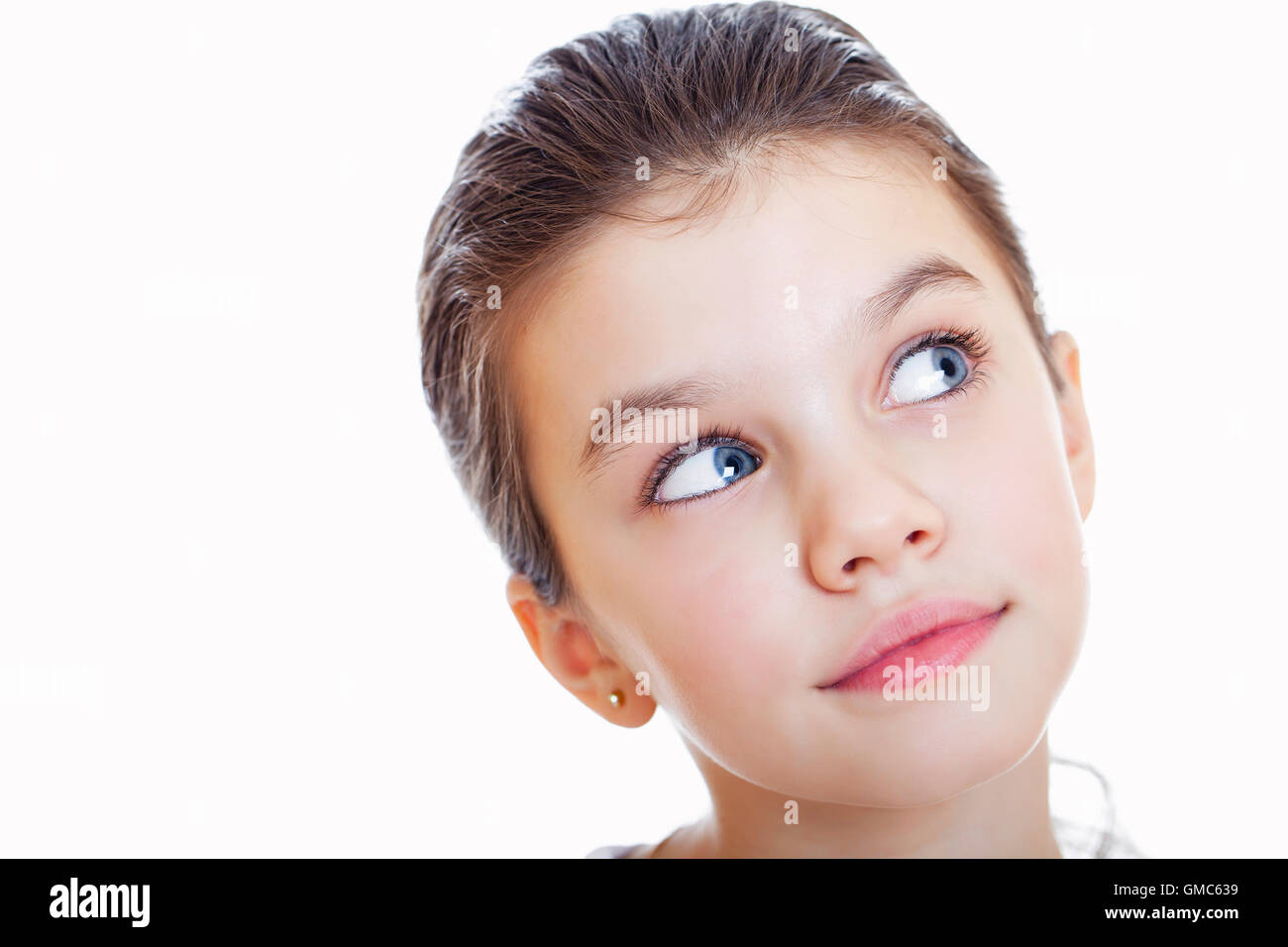 Portrait of a charming little girl smiling at camera, isolated on white ...