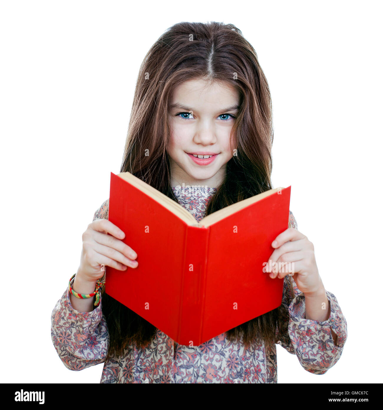 Little girl holding red book, studio on white background Stock Photo Alamy