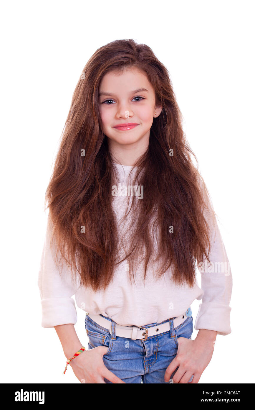 Portrait of a charming little girl smiling at camera, isolated on white ...