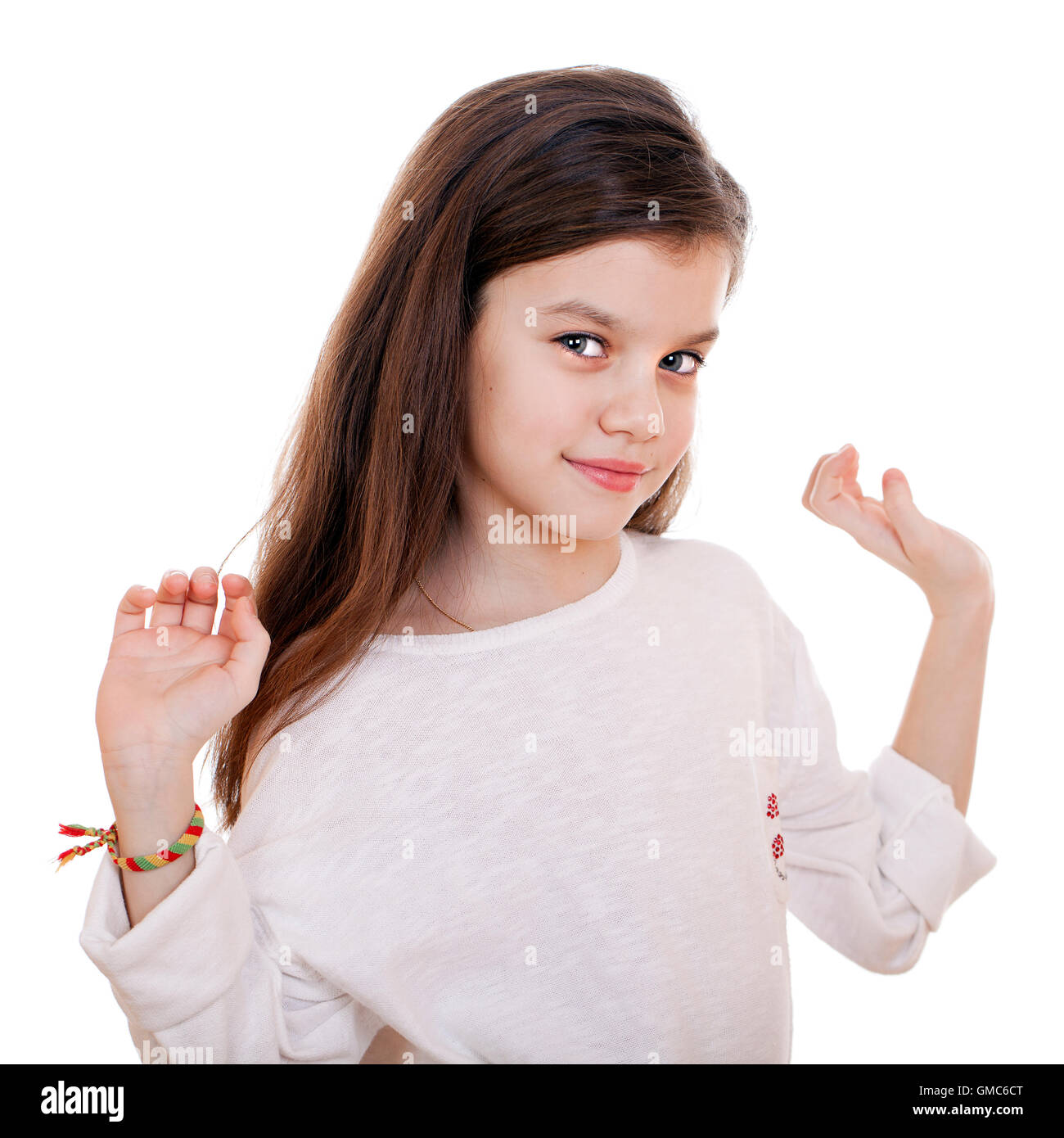 Portrait of a charming little girl smiling at camera, isolated on white ...