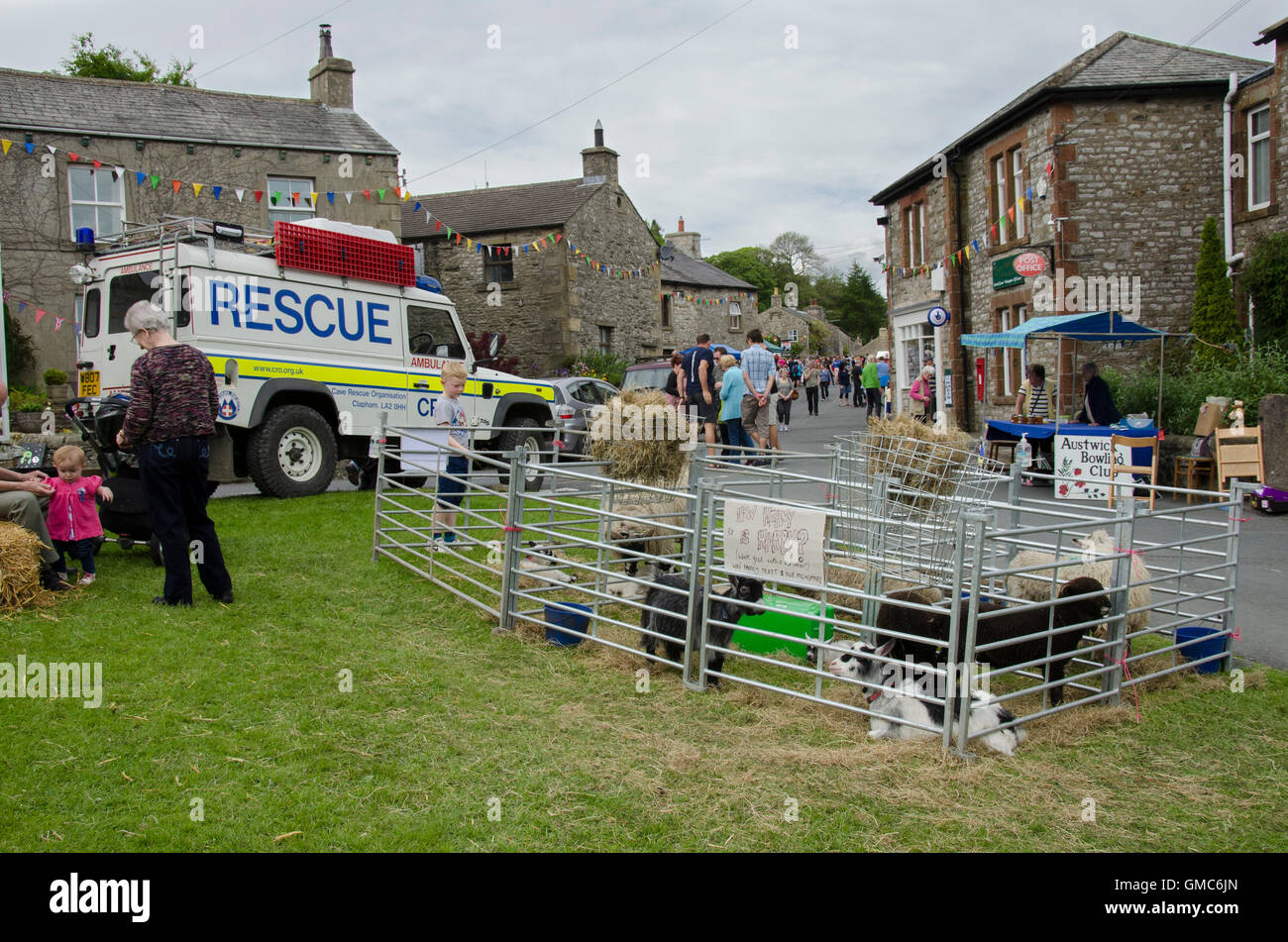 Sheep pens and displays on Austwick village green at the time of the Cuckoo Festival & Street Market - Yorkshire Dales, England. Stock Photo