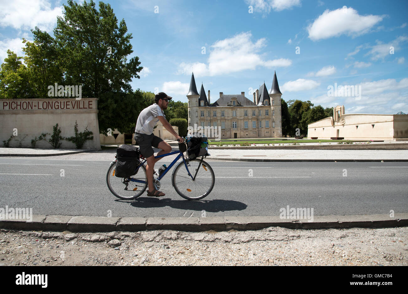 Chateau Pichon Longueville Pauillac France  A man cycling past this historic French wine estate in the Pauillac region of Borde Stock Photo