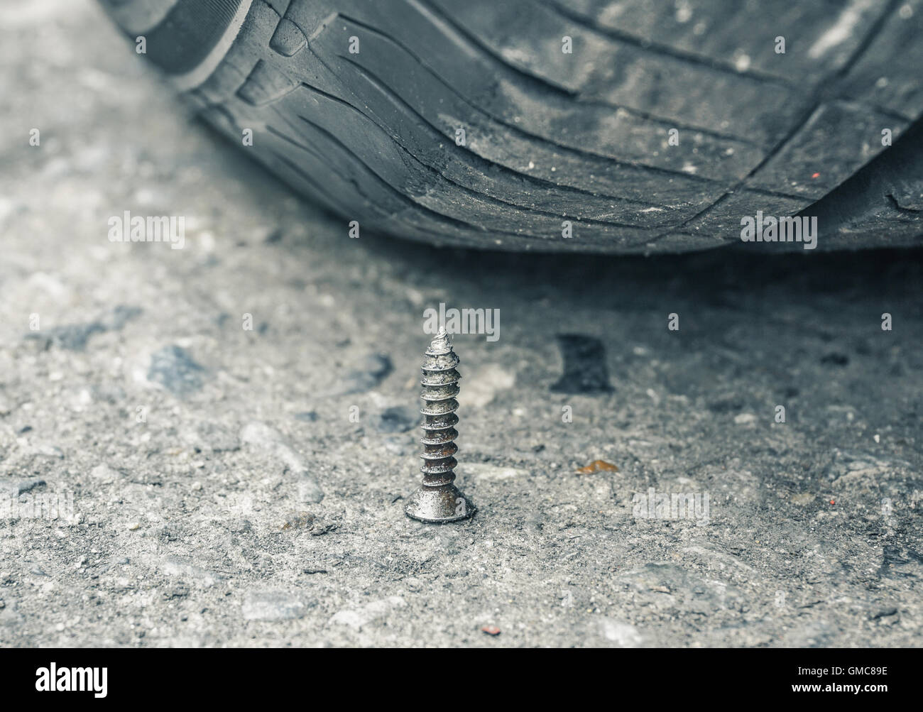 Sharpen metal screw nail nearly to puncture into wheel tire, selective