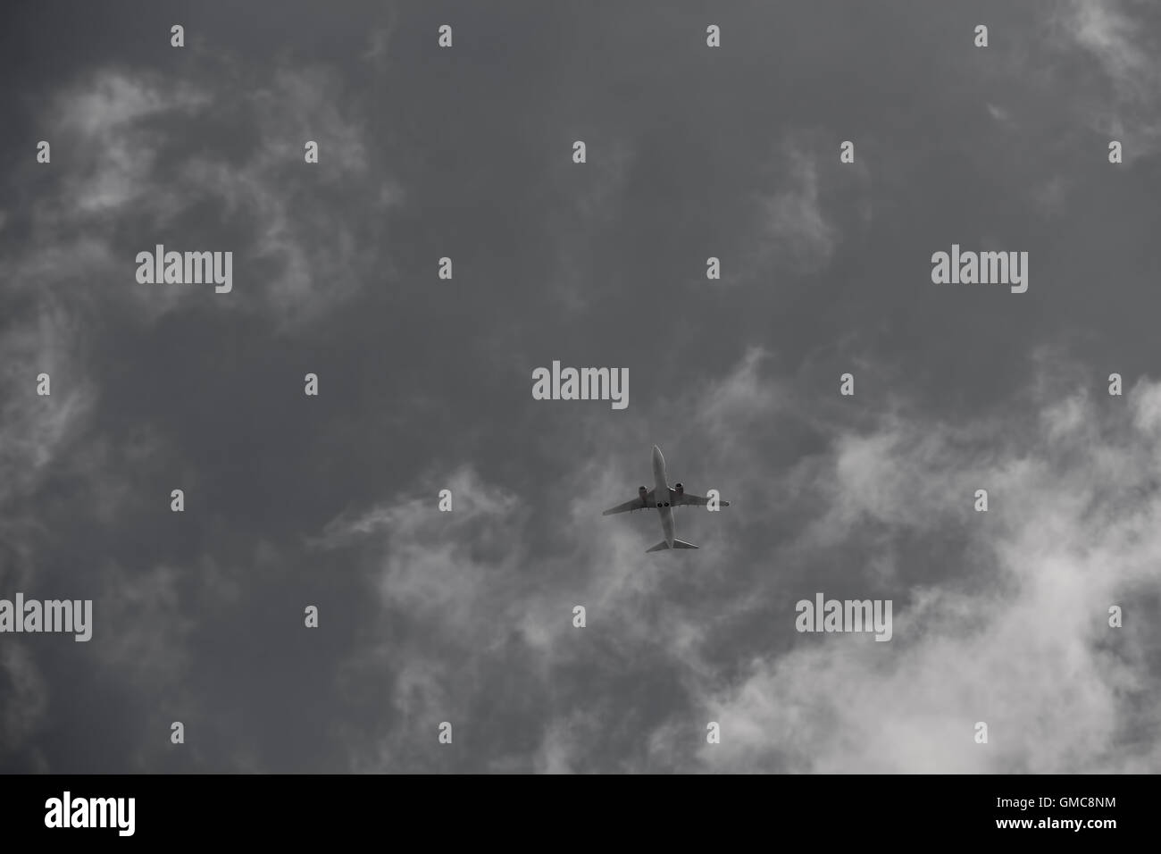 Civil aircraft cloud sky in black and white. Stock Photo