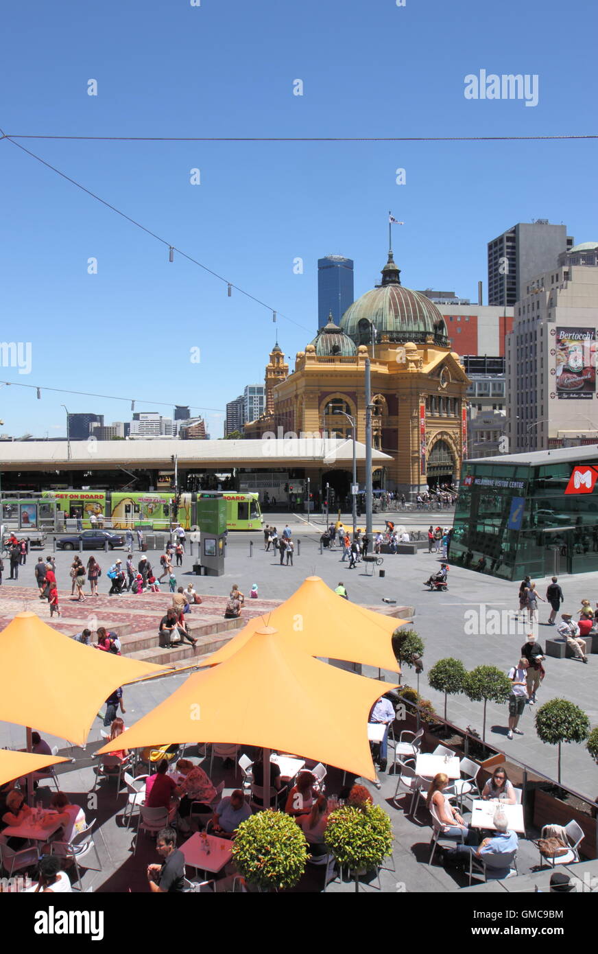 People relax in Federation Square in Melbourne Australia. Stock Photo