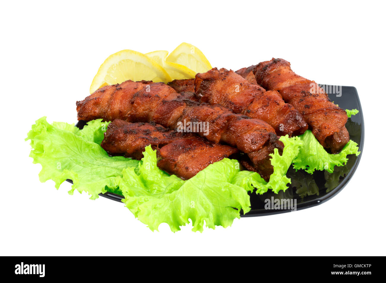 Roasted meat wrapped in bacon on the dish stock photo alamy