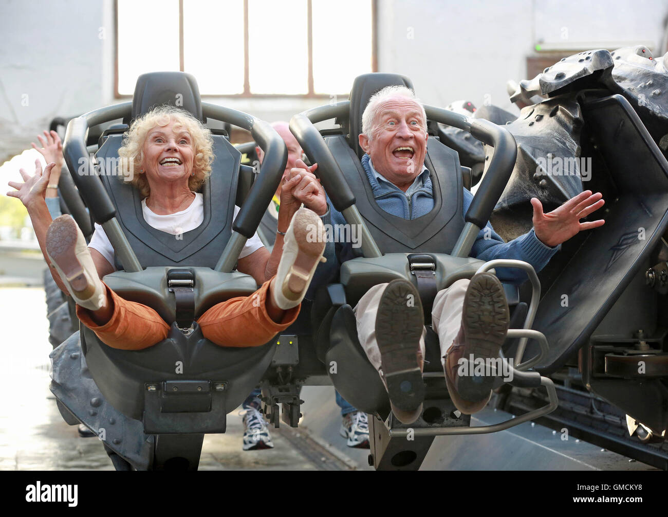 Emily Barker, 71, and Tony Barrett, 80, celebrate the launch of the Old Age Coaster Pass, the first UK discounted pass for pensioners, at Thorpe Park Resort, Surrey. Stock Photo