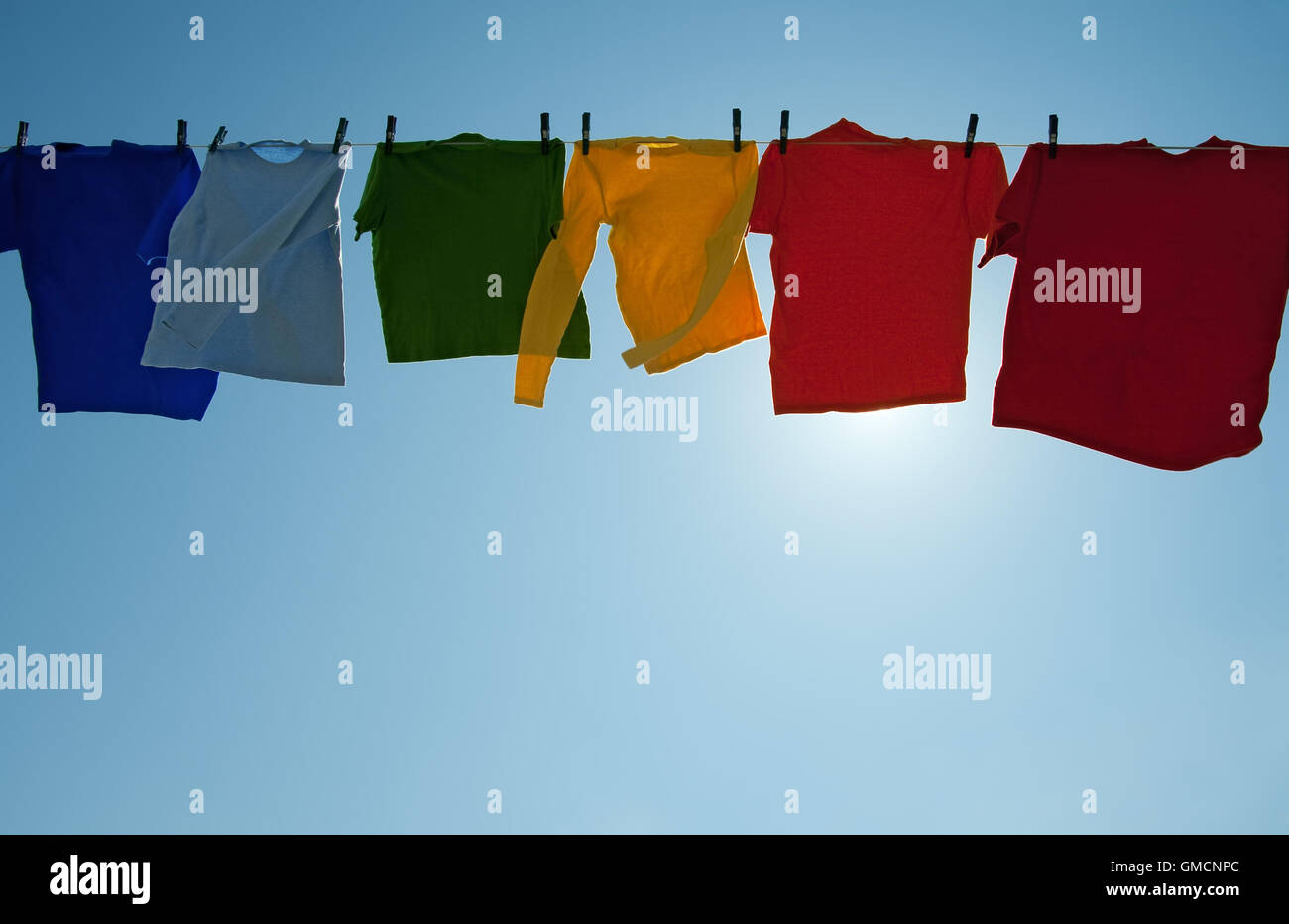 Sun shining through colorful clothes drying in the wind Stock Photo Alamy