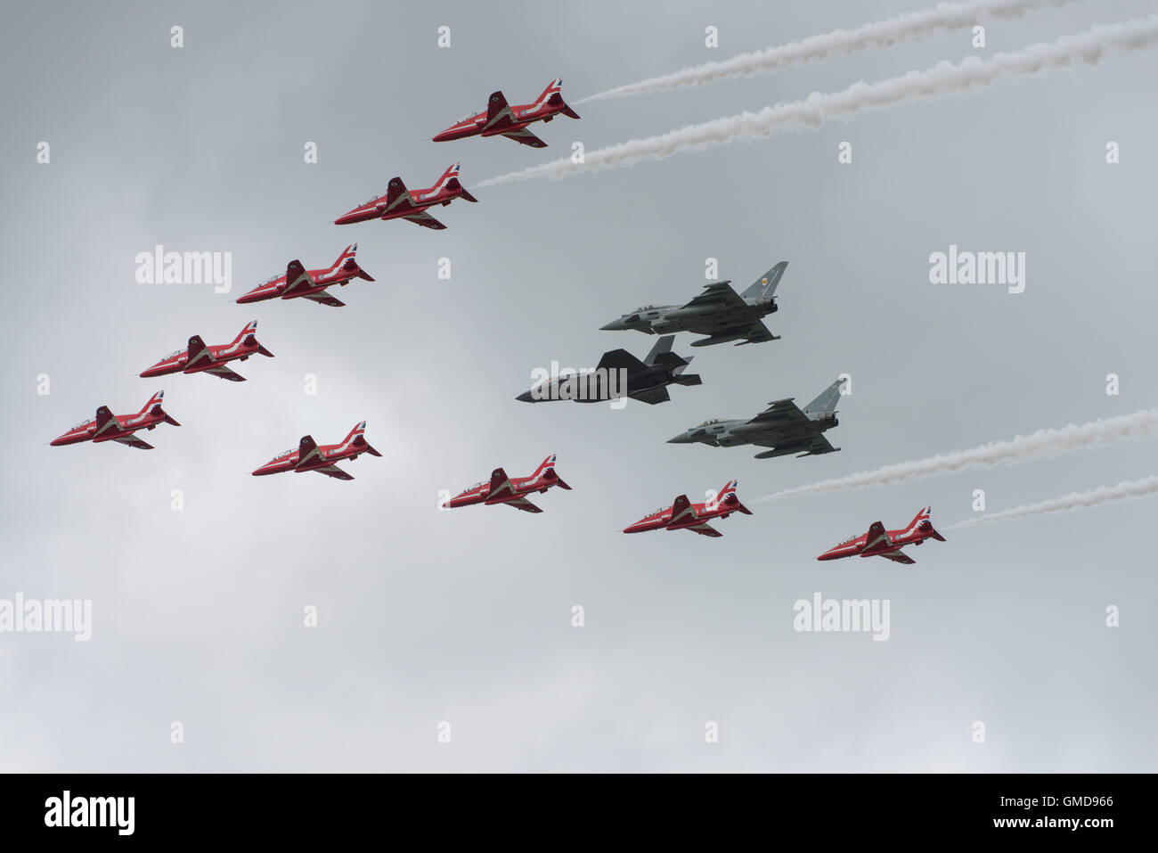 The United Kingdoms new stealth fighter jet the F-35B Lightning II flies in formation with the Red Arrows and two Typhoon FGR4's Stock Photo
