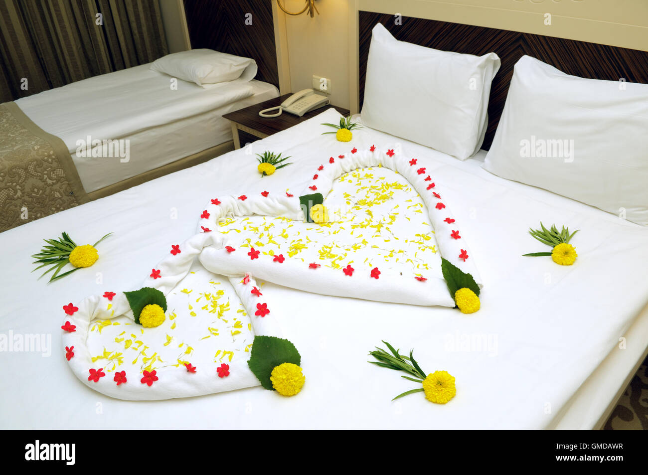 Bed Suite decorated with flowers and towels. Stock Photo