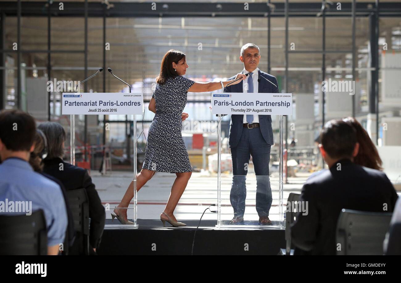 Mayor of Paris Anne Hidalgo adjusts Mayor of London Sadiq Khan's microphone during a press conference at Station F in Paris, France. Stock Photo