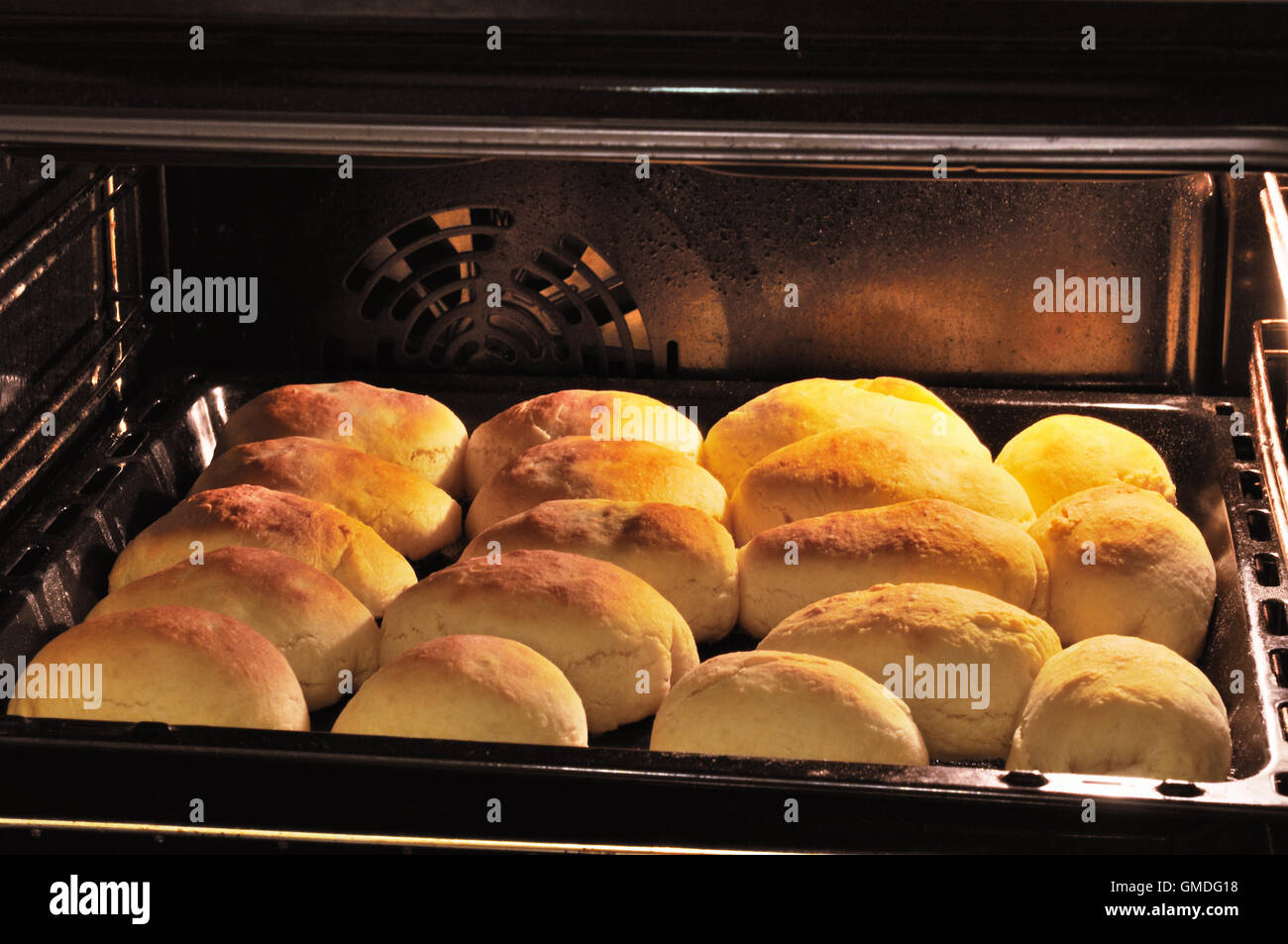 Buns on a baking sheet in oven Stock Photo - Alamy