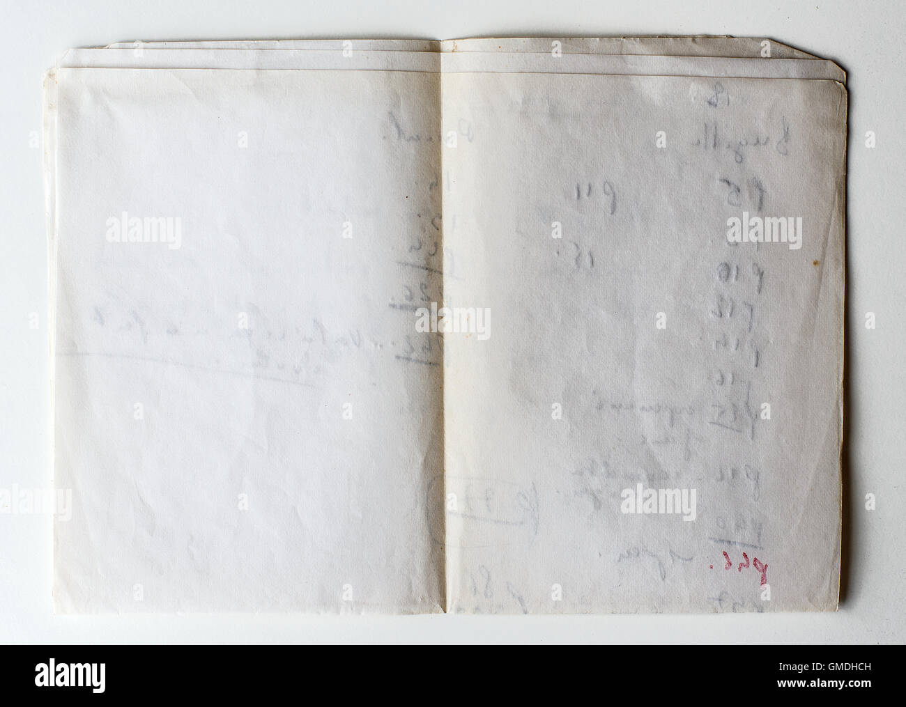 Old grunge paper on white background with handwriting on the reverse. Stock Photo