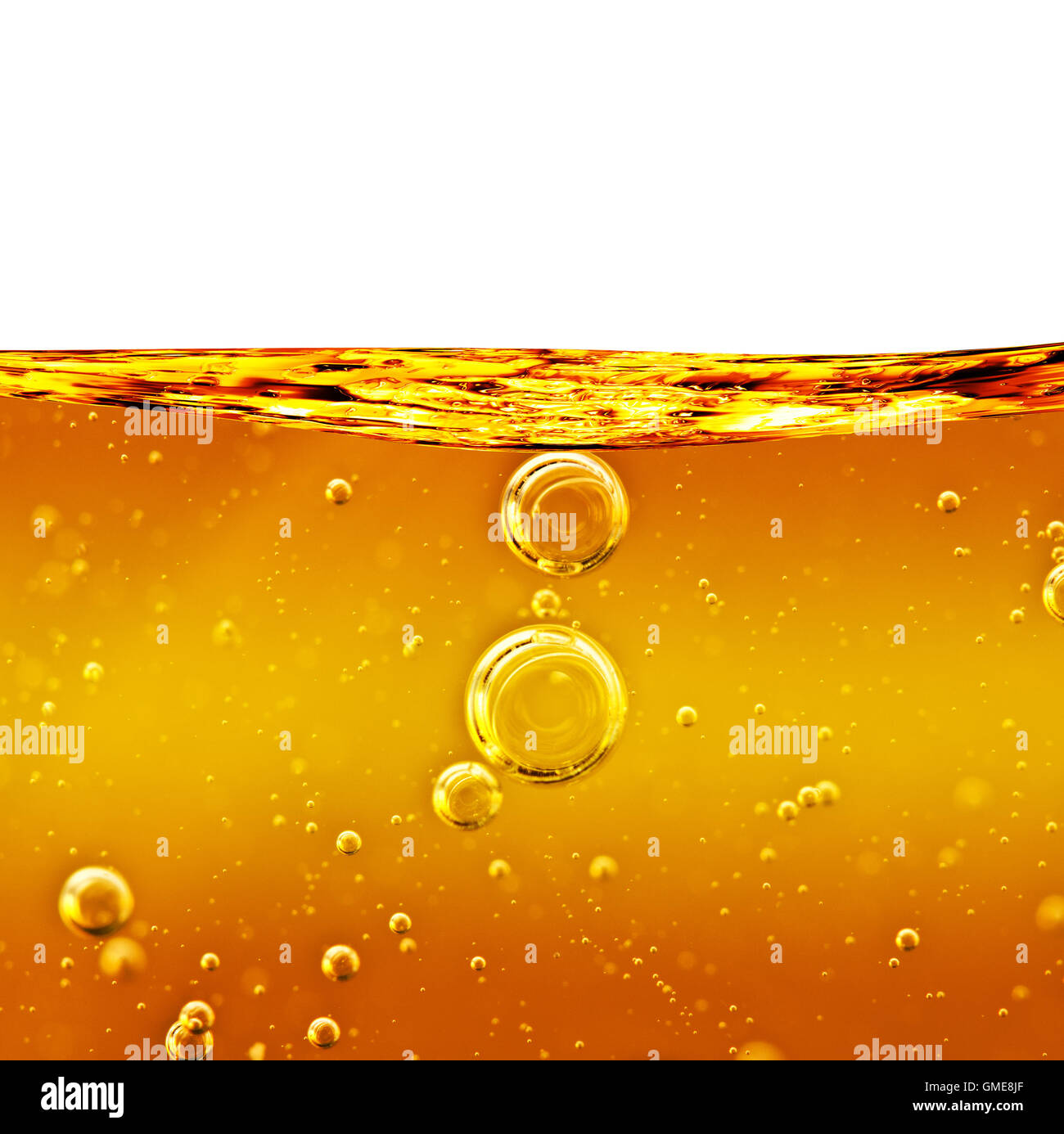 Oil background. Wave from yellow liquid with air bubbles Stock Photo