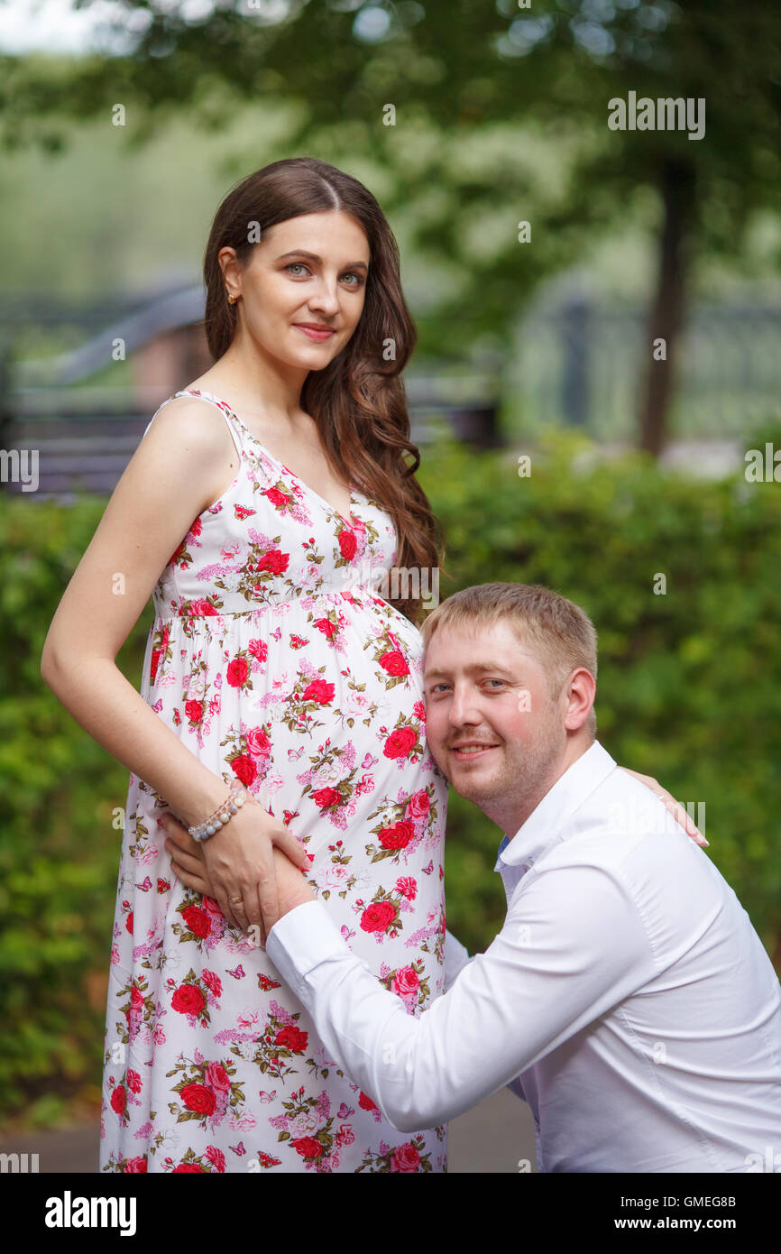 Pregnant woman with husband walking in the park Stock Photo - Alamy