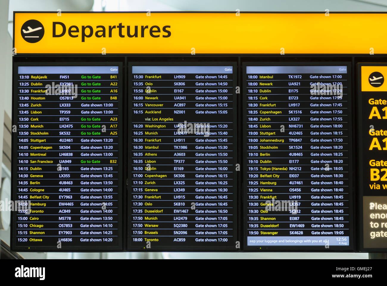 Flight departures information notice board sign at Heathrow airport Terminal 2 departure lounge showing times. LHR. London UK Stock Photo