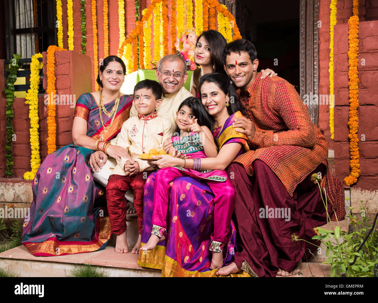 group photo of cheerful indian family in ganesh festival, happy indian