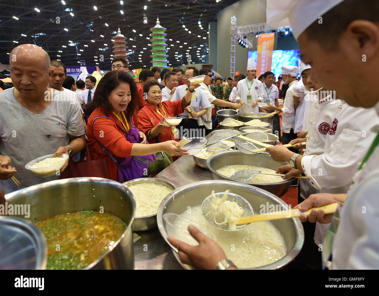 Taiyuan, China's Shanxi Province. 26th Aug, 2016. Visitors have a taste of newly-cooked sliced noodles at the 1st Shanxi cooked wheaten food festival in Taiyuan, capital of north China's Shanxi Province, Aug. 26, 2016. The food festival kicked off here Friday. Credit:  Cao Yang/Xinhua/Alamy Live News Stock Photo