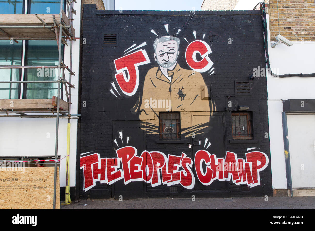London, UK. 26th Aug, 2016. A man walks by a wall painted in support of Labour Party leader Jeremy Corbyn in the London borough of Camden. Corbyn is battling Owen Smith for leadership of the Labour Party which is to be decided on September 24, 2016. Credit:  Joel Ford/Alamy Live News Stock Photo