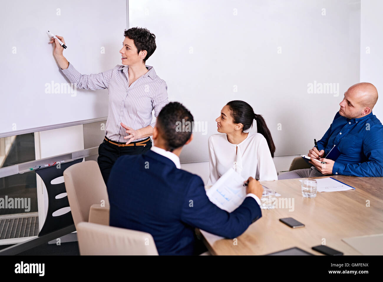 Mature businesswoman making an enthusiastic presentation to potential investors Stock Photo