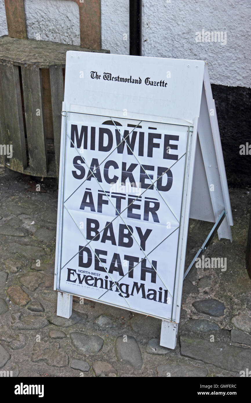 The Westmorland Gazette newspaper advertising board showing Midwife Sacked after Baby Death headline in North West Evening Mail Stock Photo