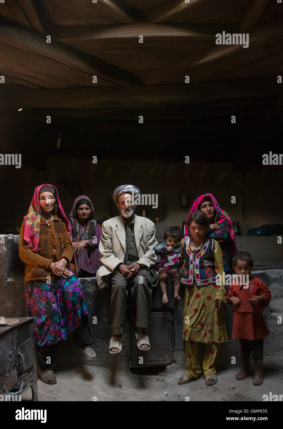 Afghan family inside their traditional pamiri house, Badakhshan province, Wuzed, Afghanistan Stock Photo